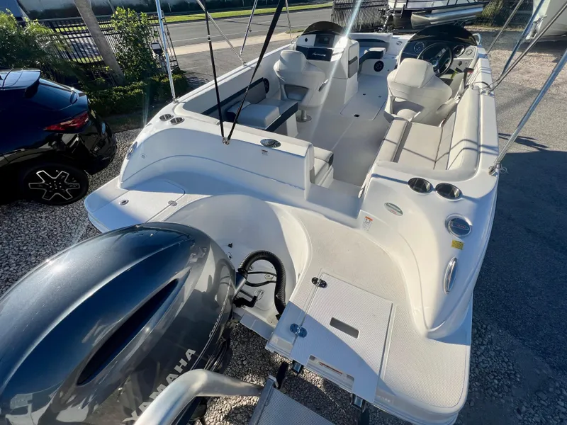 Slide: The Image of 2023 Hurricane 218 SS boat with Yamaha engine, spacious seating, and modern design. - 8