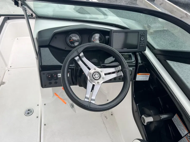 Slide: The Image of 2017 Yamaha AR195 boat dashboard with steering wheel and control panel. - 6
