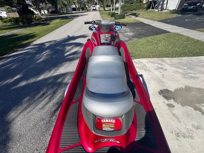 Slide: The Image of 2014 Yamaha WaveRunner VX Cruiser, red, parked on a sunny residential street. - 12