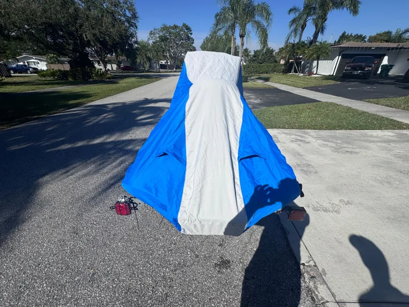 Slide: The Image of 2014 Yamaha WaveRunner VX Cruiser covered with blue and white tarp on driveway. - 16
