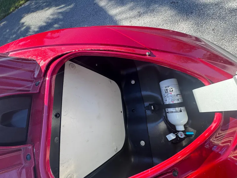 Slide: The Image of Open storage compartment of 2014 Yamaha WaveRunner VX Cruiser with fire extinguisher inside. - 18