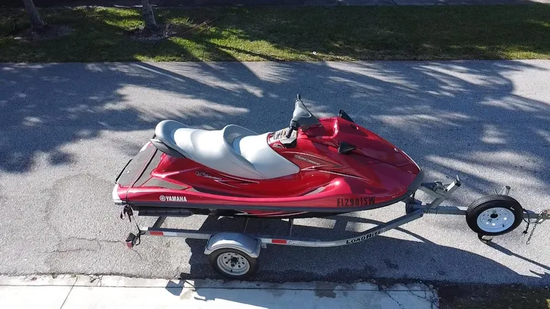 Slide: The Image of 2014 Yamaha WaveRunner VX Cruiser on trailer, parked on a sunny street. - 2