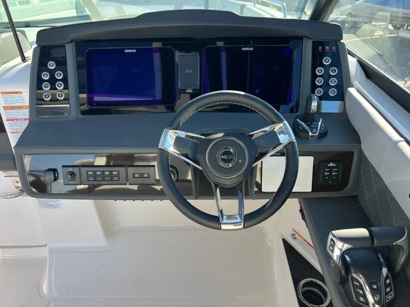 Slide: The Image of 2025 Chaparral 310 OSX helm with dual displays and modern controls. - 11