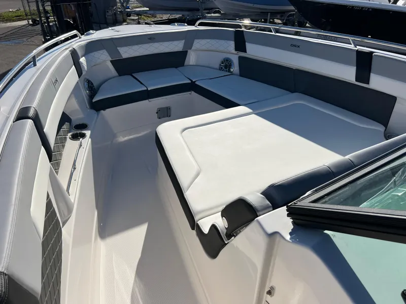Slide: The Image of 2025 Chaparral 310 OSX boat interior with spacious seating and modern design. - 13