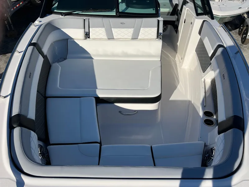 Slide: The Image of 2025 Chaparral 310 OSX boat interior with luxurious white seating. - 14