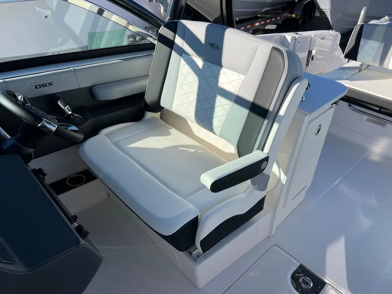 Slide: The Image of 2025 Chaparral 310 OSX boat interior with modern seating and sleek design. - 16