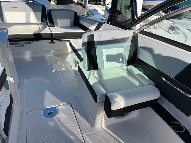 Slide: The Image of 2025 Chaparral 310 OSX boat interior with modern seating and sleek design. - 17