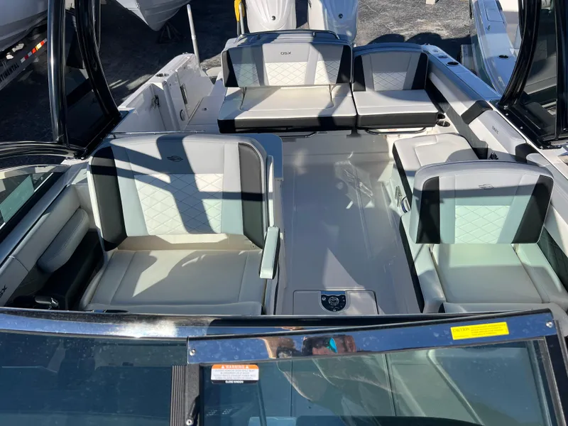 Slide: The Image of 2025 Chaparral 310 OSX boat interior with luxurious seating and modern design. - 19