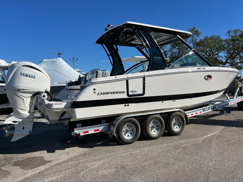 Slide: The Image of 2025 Chaparral 310 OSX boat on trailer with Yamaha engine, side view. - 2