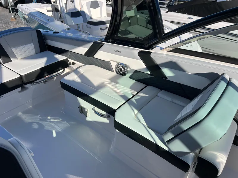 Slide: The Image of 2025 Chaparral 310 OSX boat interior with sleek seating and modern design. - 21