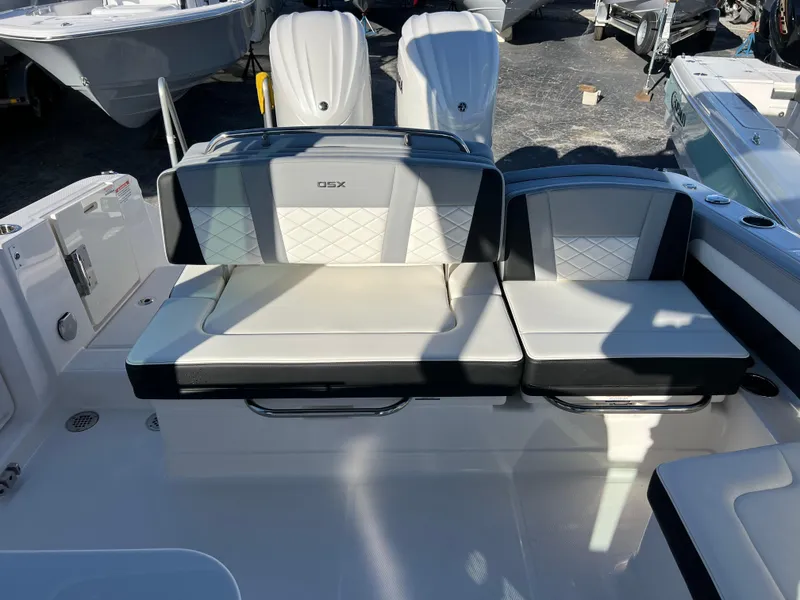 Slide: The Image of 2025 Chaparral 310 OSX boat seating area with cushioned seats and backrests. - 22