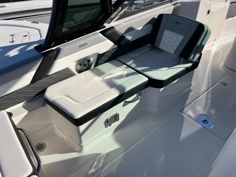 Slide: The Image of 2025 Chaparral 310 OSX boat interior with cushioned seating and sleek design. - 9