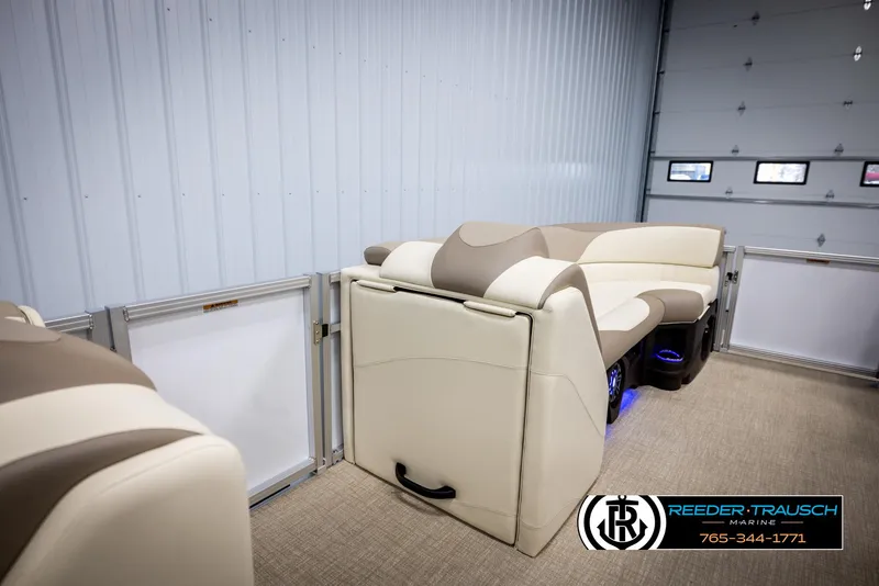 Slide: The Image of 2025 Avalon LSZ CRB pontoon boat interior with beige seating in a showroom. - 20