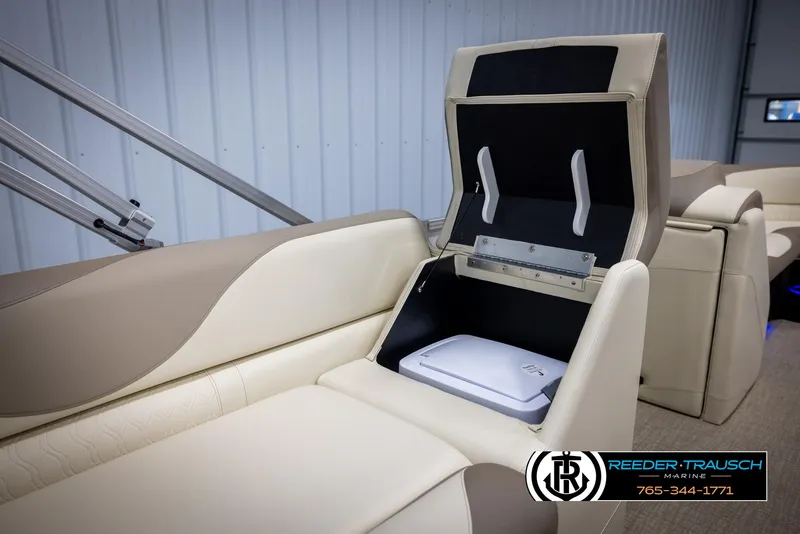 Slide: The Image of 2025 Avalon LSZ CRB boat interior with open storage compartment and beige seating. - 23