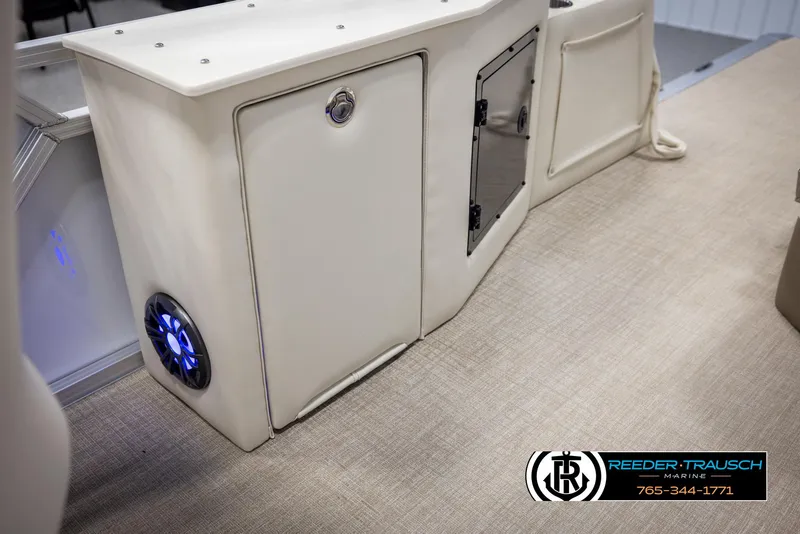 Slide: The Image of 2025 Avalon LSZ CRB boat interior with storage compartments and illuminated speaker. - 24