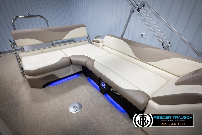 Slide: The Image of Luxurious 2025 Avalon LSZ CRB boat interior with beige seating and blue LED lighting. - 26