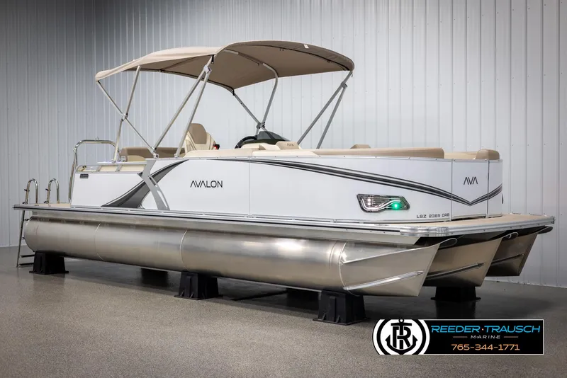 Slide: The Image of 2025 Avalon LSZ CRB pontoon boat with canopy in showroom, side view. - 3