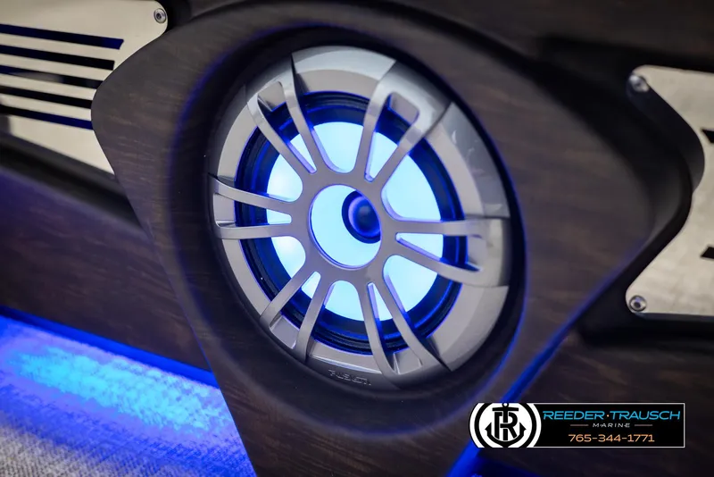 Slide: The Image of Close-up of illuminated speaker on 2025 Avalon LSZ CRB boat, featuring blue LED lighting. - 43