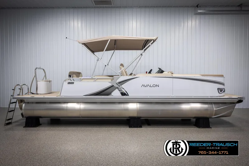 Slide: The Image of 2025 Avalon LSZ CRB pontoon boat with canopy in showroom, side view. - 5