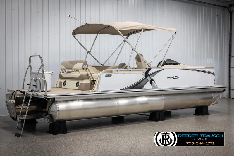 Slide: The Image of 2025 Avalon LSZ CRB pontoon boat with canopy in showroom, featuring sleek design and comfortable seating. - 6