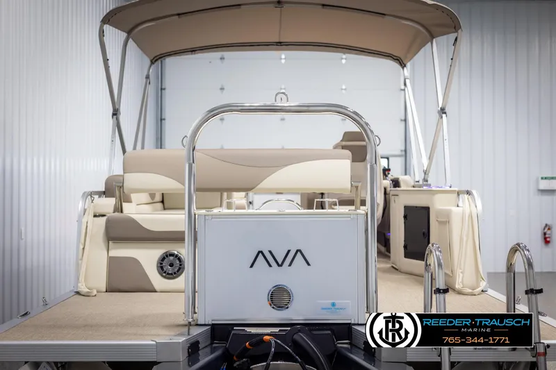 Slide: The Image of 2025 Avalon LSZ CRB pontoon boat with beige seating and canopy in a showroom. - 7
