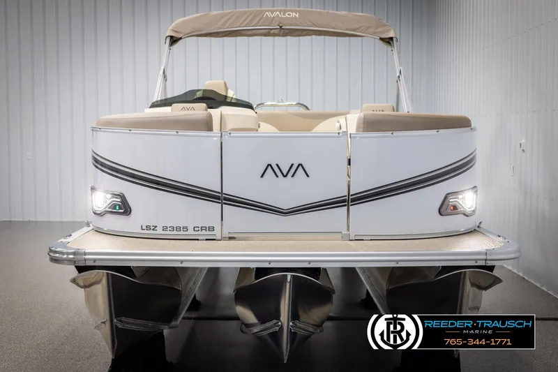 Slide: The Image of 2025 Avalon LSZ CRB pontoon boat in showroom, front view with logo and lights. - 8