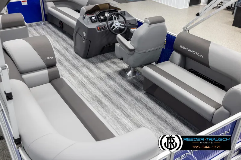 Slide: The Image of 2025 Bennington 21 SSRSE pontoon boat interior with gray seating and modern dashboard. - 10