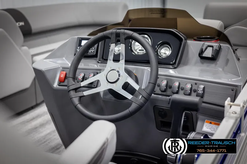 Slide: The Image of 2025 Bennington 21 SSRSE boat dashboard with steering wheel and control panel. - 22