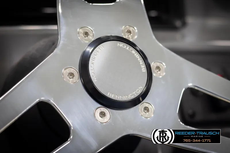 Slide: The Image of Close-up of 2025 Bennington 21 SSRSE steering wheel with logo detail. - 24