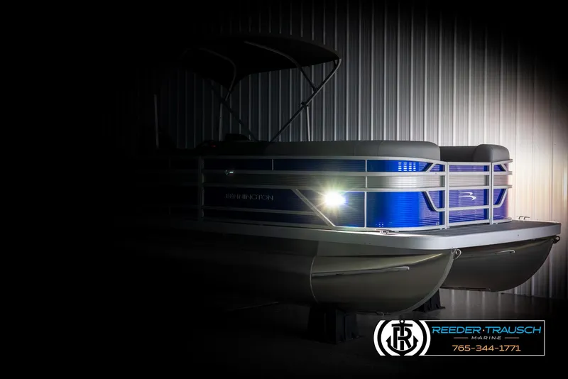 Slide: The Image of 2025 Bennington 21 SSRSE pontoon boat in dimly lit showroom. - 3