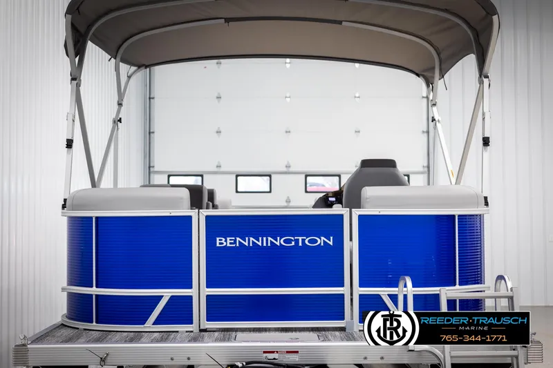 Slide: The Image of 2025 Bennington 21 SSRSE pontoon boat with blue exterior in showroom. - 6