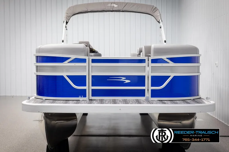 Slide: The Image of 2025 Bennington 21 SSRSE pontoon boat with blue and silver design in showroom. - 7