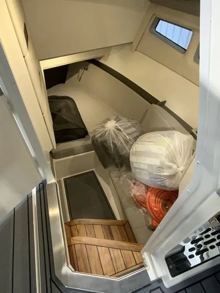 Slide: The Image of Interior cabin of 2025 Cobalt R35 boat with storage and wooden flooring. - 11