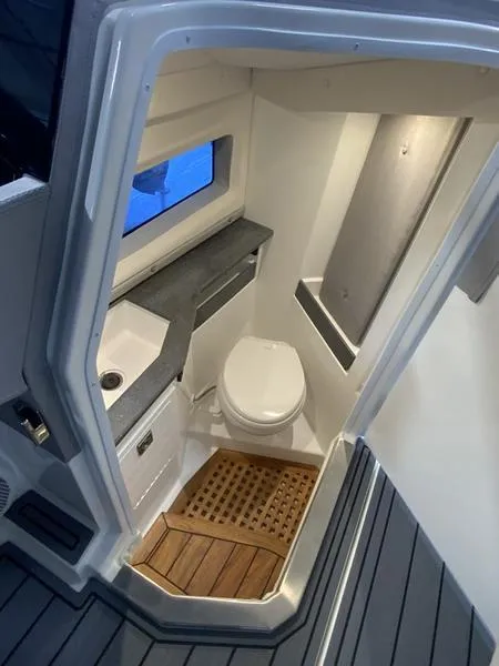 Slide: The Image of 2025 Cobalt R35 boat bathroom with modern fixtures and wooden flooring. - 12