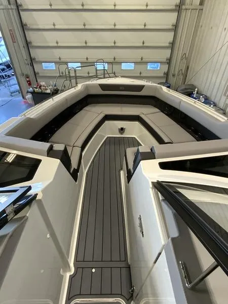 Slide: The Image of 2025 Cobalt R35 boat interior with sleek seating and modern design in a spacious garage. - 13