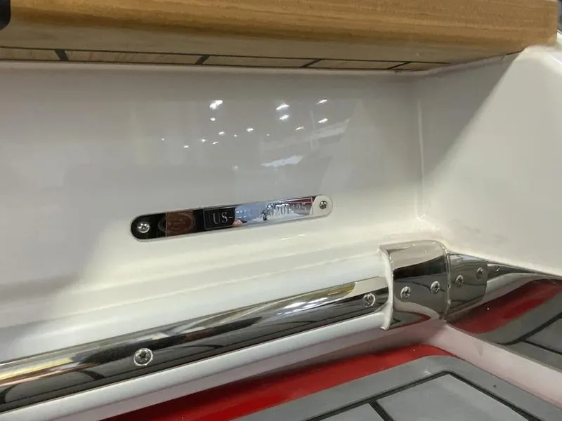 Slide: The Image of 2025 Cobalt R35 boat interior detail with metal and wood accents. - 16