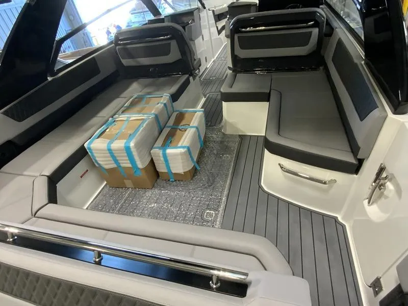 Slide: The Image of Interior of 2025 Cobalt R35 boat with packages on gray seating area. - 6