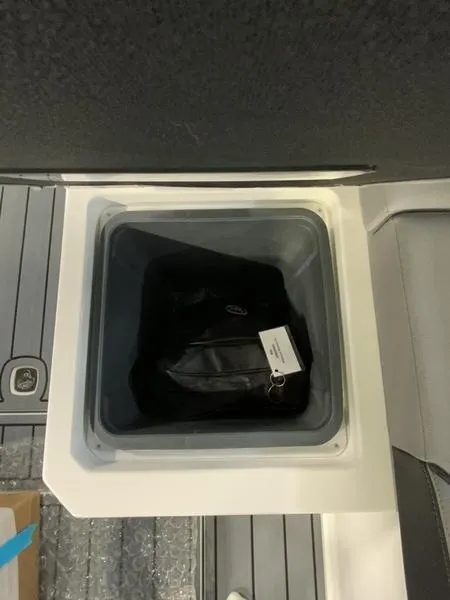 Slide: The Image of Storage compartment in 2025 Cobalt R35 boat, containing a black bag. - 7