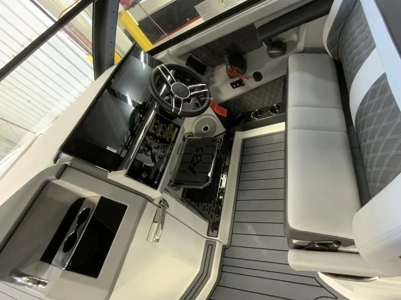 Slide: The Image of 2025 Cobalt R35 boat interior with modern steering and seating. - 8