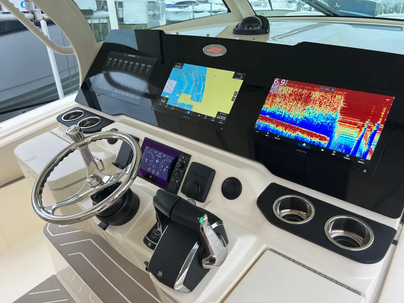 Slide: The Image of 2025 Scout 377 LXF boat dashboard with advanced navigation and sonar displays. - 16