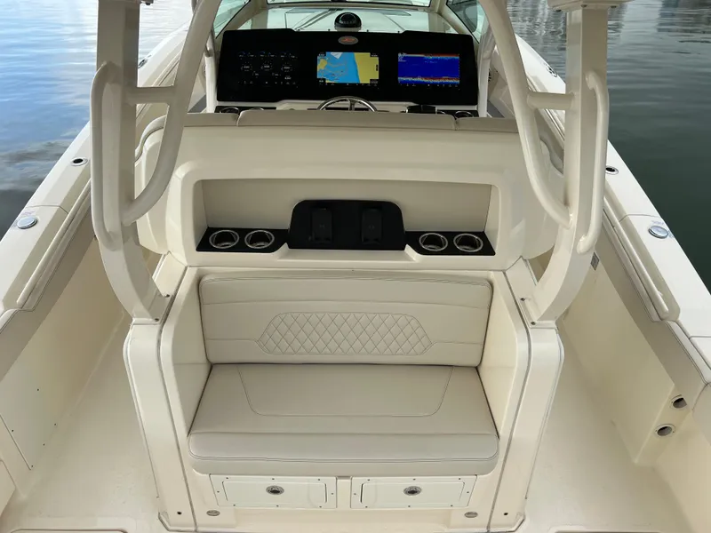 Slide: The Image of 2025 Scout 377 LXF boat interior with seating, cup holders, and navigation screens. - 18