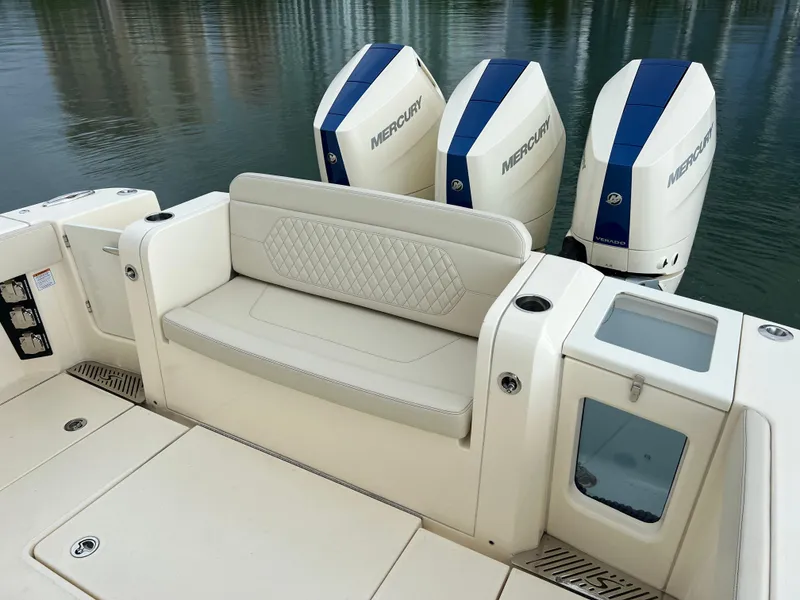 Slide: The Image of 2025 Scout 377 LXF boat with triple Mercury engines and luxurious seating. - 20