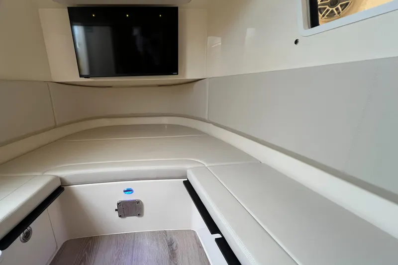 Slide: The Image of 2025 Scout 377 LXF cabin interior with TV, featuring sleek beige seating and modern design. - 21