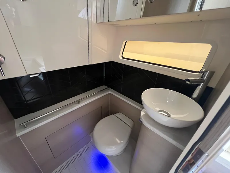 Slide: The Image of Luxurious bathroom in 2025 Scout 377 LXF boat with modern fixtures and ambient lighting. - 23
