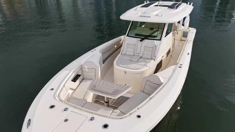 Slide: The Image of 2025 Scout 377 LXF luxury boat on calm water, featuring spacious seating and modern design. - 3
