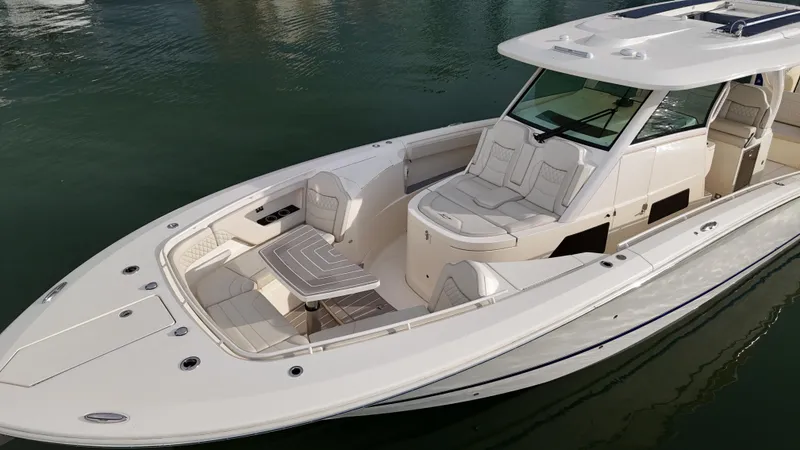 Slide: The Image of 2025 Scout 377 LXF luxury boat with sleek design and spacious seating on calm water. - 6