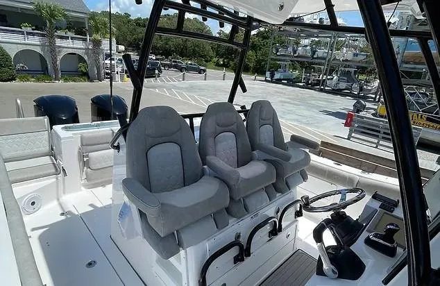 Slide: The Image of 2021 Sea Fox 328 Commander boat interior with three cushioned seats and dual engines. - 18
