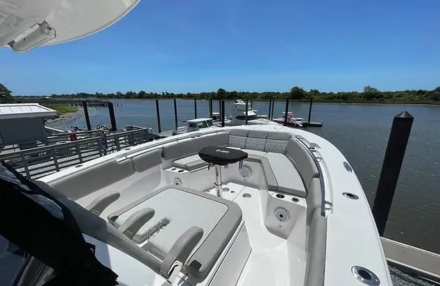 Slide: The Image of 2021 Sea Fox 328 Commander boat docked by a serene river. - 19