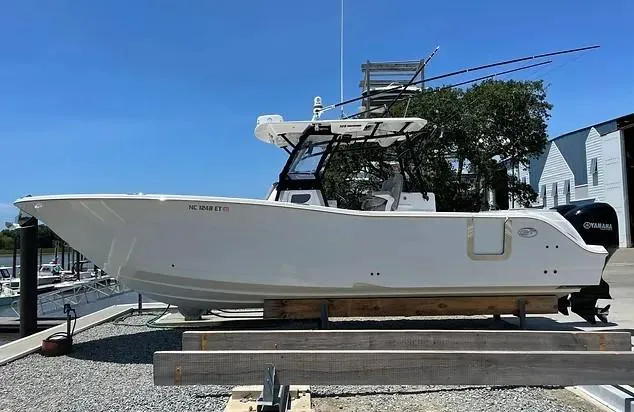 Slide: The Image of 2021 Sea Fox 328 Commander boat on display at a marina. - 2