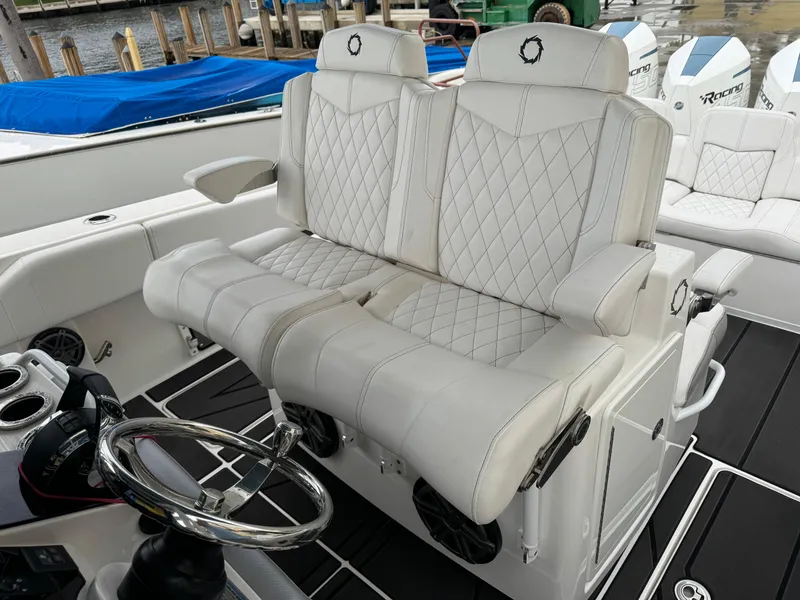 Slide: The Image of Luxurious white seating on 2019 Fountain 38 CC boat, featuring diamond stitching and sleek design. - 13